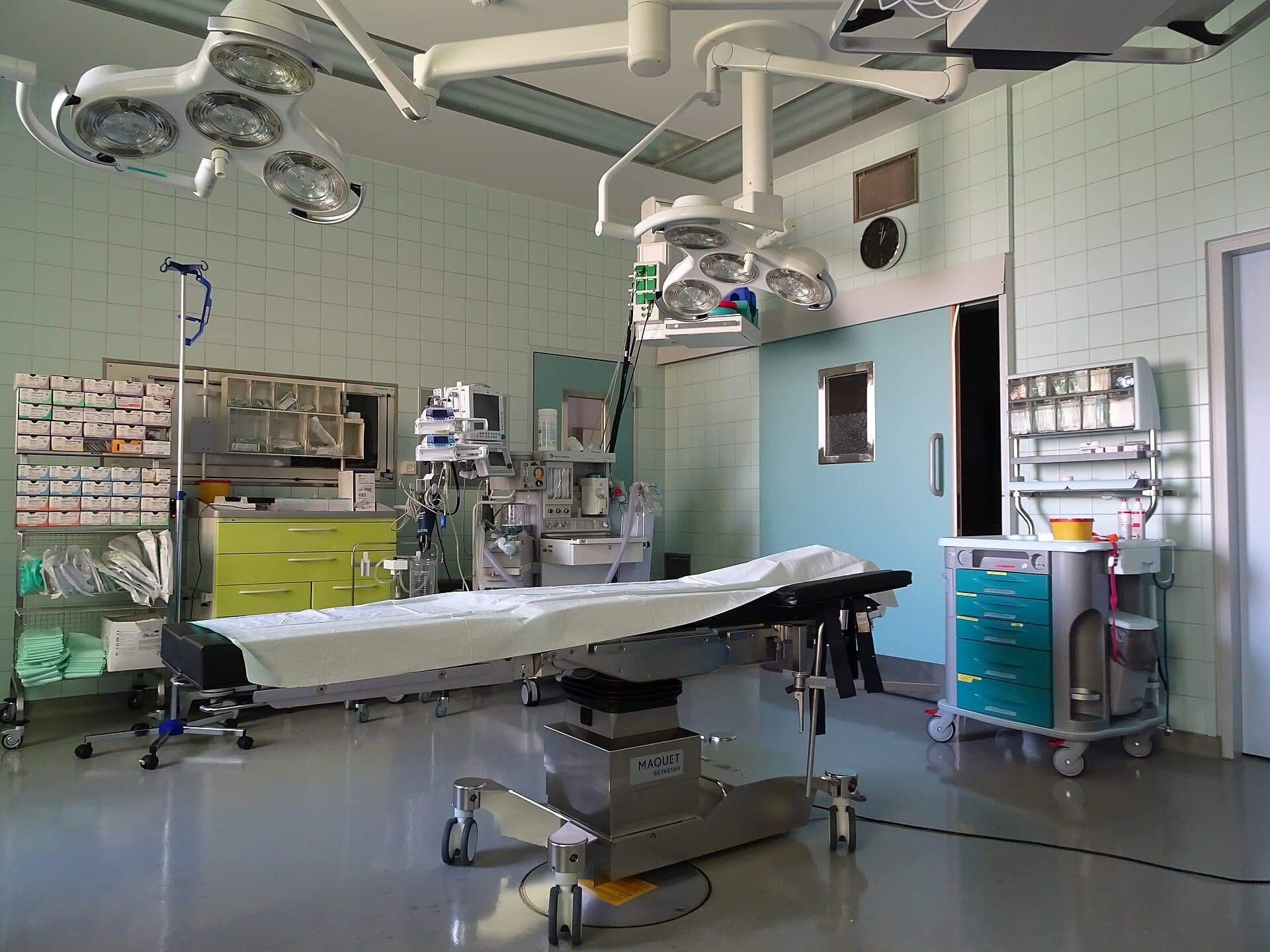 A hospital operating room with surgical lights and equipment